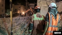 Rescuers remove debris in the hopes of finding survivors trapped in the rubble of the Metropol building in Abadan on June 2.
