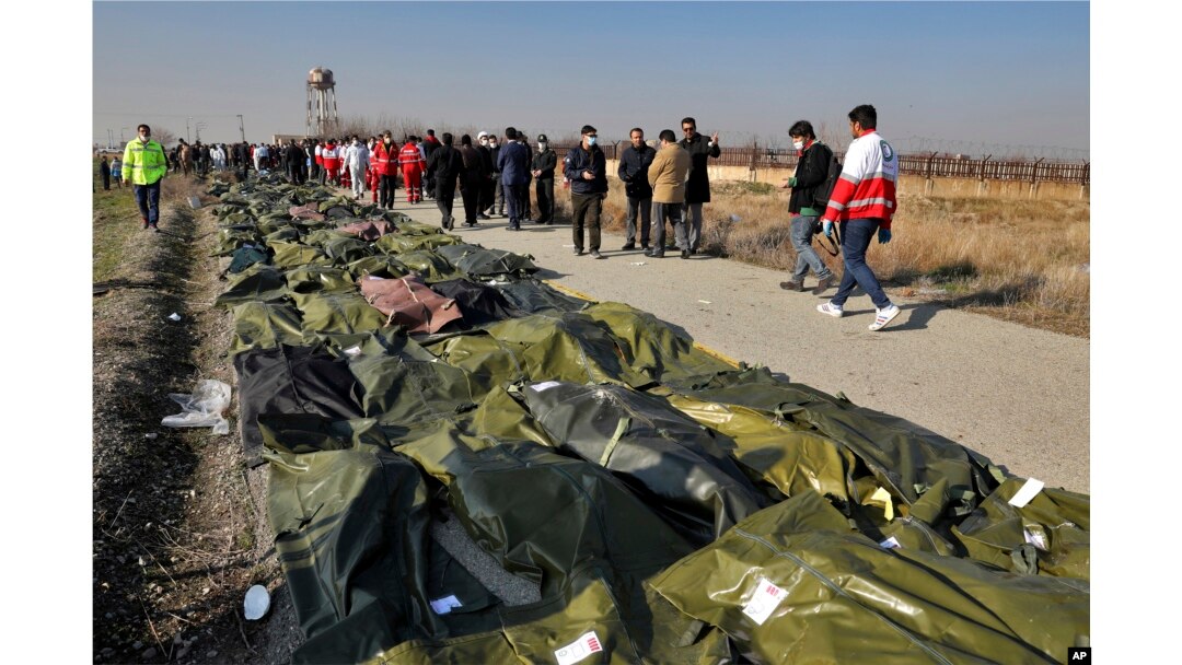 Bodies of the victims of the plane crash are collected by rescue team at the scene in Shahedshahr, southwest of the capital, Tehran, on January 8, 2020.
