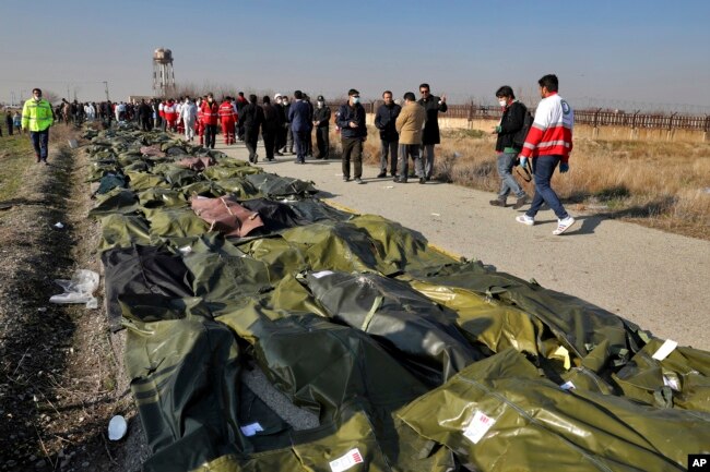 Bodies of the victims of the plane crash are collected by rescue team at the scene in Shahedshahr, southwest of the capital, Tehran, on January 8, 2020.