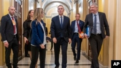 NATO Secretary General Jens Stoltenberg (center) walks through the U.S. Capitol between meetings with Republican and Democratic leaders to discuss the importance of renewing aid to Ukraine on January 30.