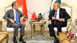 Pakistani Foreign Minister Ishaq Dar (right) speaks with his Chinese counterpart, Wang Yi, during a meeting in Islamabad in August 2025. 
