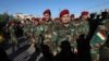 Kurdish Peshmerga fighters line up before voting for parliamentary elections in Iraq's Kurdish region outside a polling station in Irbil on September 28 as Kurdish armed forces voted ahead of the general public.