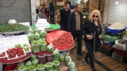 Iranians shop for fruit and vegetables in a market in northern Tehran on April 21, 2026.