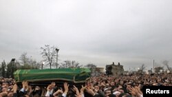 People carry the coffin of former Prime Minister Necmettin Erbakan during a funeral prayer.