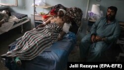 Afghan civilians who were injured in bomb blasts receive medical treatment at a hospital in Herat on May 24.