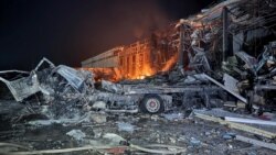 The headquarters of a commercial building burns after it was hit by Russian missile strikes in Kharkiv, Ukraine, on January 13.