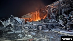 The headquarters of a commercial building burns after it was hit by Russian missile strikes in Kharkiv, Ukraine, on January 13.