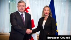 Georgian Prime Minister Giorgi Kvirikashvili (left) and EU foreign-policy chief Federica Mogherini pose during an EU-Georgia Association Council meeting in Brussels on February 5.