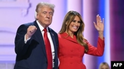 Former U.S. President and 2024 Republican presidential candidate Donald Trump raises a fist next to his wife, Melania, during the last day of the 2024 Republican National Convention in Milwaukee, Wisconsin, on July 18. 