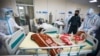 Afghan health workers carry the body of a coronavirus victim from the ICU ward at the Afghan-Japan Hospital for Covid-19 patients in Kabul on June 9.