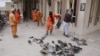 Workers clean the scene of a suicide bomb attack that targeted a Shi'ite mosque in Kabul on November 21.