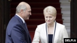 Lithuanian President Dalia Grybauskaite greets her Belarusian counterpart Alyaksandr Lukashenka in Vilnius.