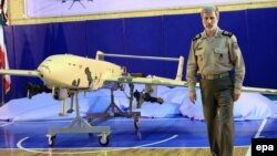 Iranian Deputy Defense Minister Brigadier General Amir Hatami poses with a new, locally made combat drone during an unveiling ceremony in Tehran on September 23.