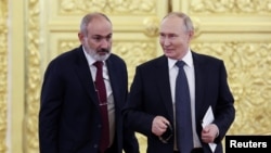 Russia - Armenian Prime Minister Nikol Pashinyan and Russian President Vladimir Putin speak during a CIS summit at the Kremlin in Moscow, October 8, 2024.