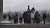 Kazakhs lay flowers to the Independence Monument in Almaty on December 17.