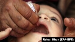 A health worker administers the polio vaccine to a child in Karachi on February 10.