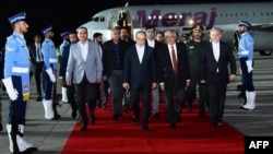Iranian Foreign Minister Abbas Araqchi (center) arrives in Islamabad for discussions with Pakistani mediators -- and possibly with US negotiators.