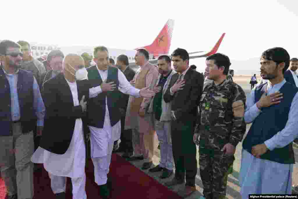 Afghan President Ashraf Ghani (in mask) arrives in Mazar-e Sharif to inspect the security situation of the northern provinces on August 11. By August 14, the city had fallen with minimum fighting to the Taliban. Ghani left Kabul for Tajikistan on August 15.