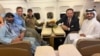 US citizen Amir Amiri (left) sits next to an unidentified woman aboard a plane in Kabul. With him (from right) are a Qatari diplomat; Sebastian Gorka, deputy assistant to the US president; and US special envoy Adam Boehler.
