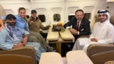 US citizen Amir Amiri (left) sits next to an unidentified woman aboard a plane in Kabul. With him (from right) are a Qatari diplomat; Sebastian Gorka, deputy assistant to the US president; and US special envoy Adam Boehler.