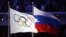 Russia -- The Olympic flag (L) and the Russian flag during the Closing Ceremony of the Sochi 2014 Olympic Games in the Fisht Olympic Stadium in Sochi,  February 23, 2014