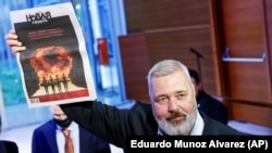 Dmitry Muratov, editor-in-chief of the influential Russian newspaper Novaya Gazeta, celebrates after auctioning off his 2021 23-karat gold medal Nobel Peace Prize at the Times Center in New York on June 20.