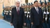 Kazakh President Qasym-Zhomart Toqaev (left) welcomes Chinese leader Xi Jinping to Astana on July 2 for a state visit and two-day SCO summit. 