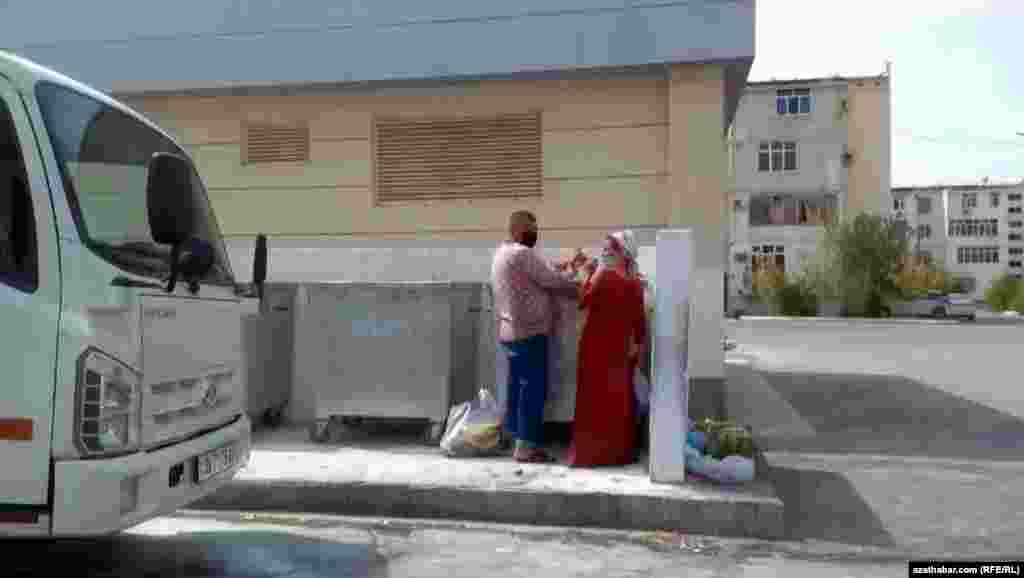 Aşgabat. Zibil çeleginden derege ýarar ýaly zat gözleýän mätäç adamlar. 2021.