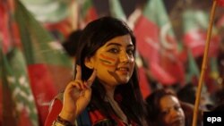 A Pakistani opposition supporter listens to a speech by Imran Khan on the seventh day of a mass antigovernment protest in Islamabad on August 21.