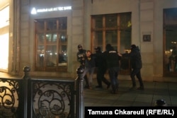 A protestor is attacked by riot police early on the morning of November 29.