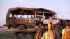 Afghan security forces remove a damaged vehicle after a bomb blast in Nangarhar Province on October 7.