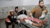 A man injured in a bomb blast at an Islamic center in Peshawar is rushed to a local hospital on January 16. 