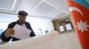 An Azeri man casts his ballot at a polling station during a presidential elections in Baku, April 11, 2018