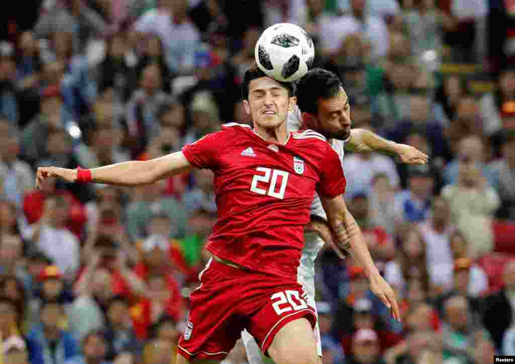 Soccer Football - World Cup - Group B - Iran vs Spain - Kazan Arena, Kazan, Russia - June 20, 2018 Iran's Sardar Azmoun in action with Spain's Sergio Busquets REUTERS/Toru Hanai