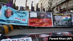 Angry Islamists chant slogans at a demonstration against the independent Pakistani newspaper Dawn outside the Press Club in Karachi on December 3.