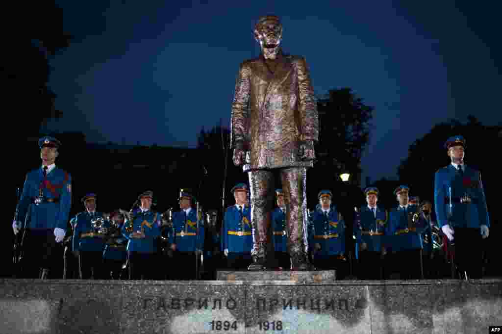 A Serbian Army honor guard stands behind a bronze statue of Gavrilo Princip after an unveiling ceremony at a park in downtown Belgrade on June 28. The Bosnian Serb nationalist, whose assassination of Archduke Franz Ferdinand 101 years ago sparked World War I, is seen as an icon of Serb patriotism. (AFP/Andrej Isakovic)