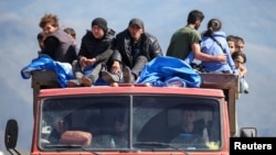 Armenia - Refugees from Nagorno-Karabakh ride in a truck upon their arrival at the border village of Kornidzor, September 27, 2023.