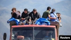 Armenia - Refugees from Nagorno-Karabakh ride in a truck upon their arrival at the border village of Kornidzor, September 27, 2023. 