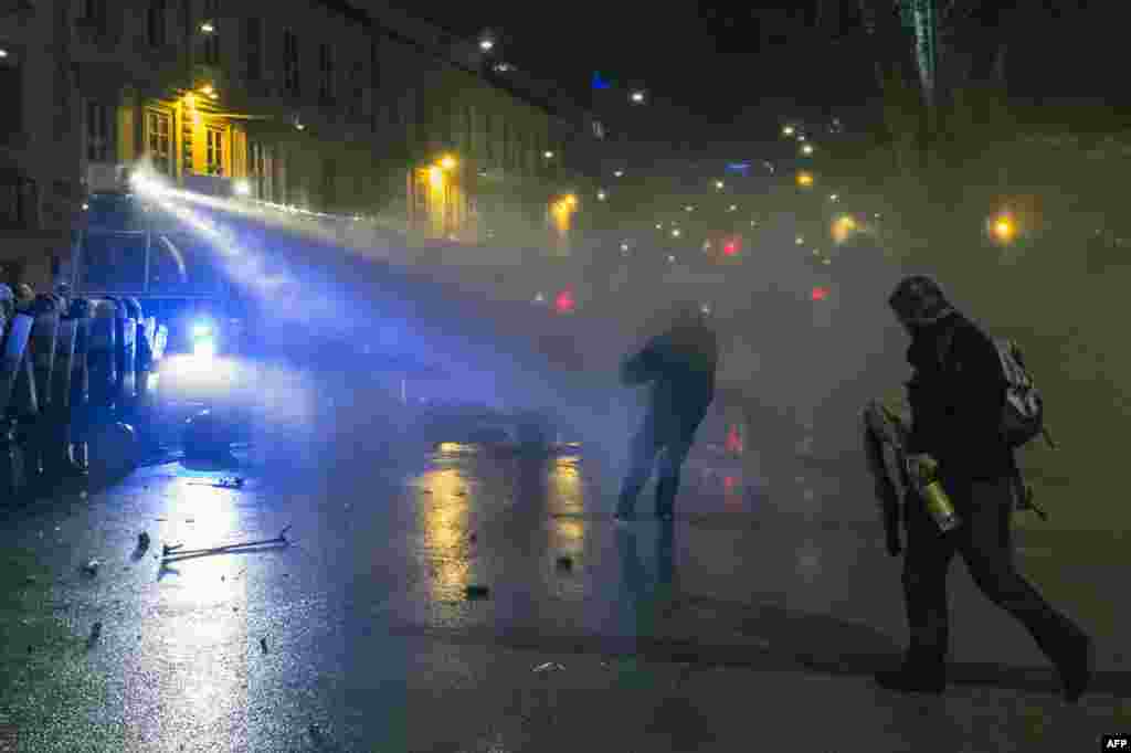 Slovenian police use a water cannon during protests against the government in Ljubljana. (AFP/Jure Makovec)