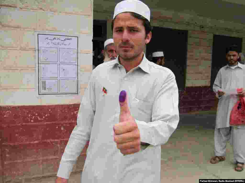 A voter shows his inked thumb in the Khyber tribal district after casting his ballot.