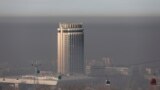 KAZAKHSTAN -- Cable cars are seen against the backdrop of the smog-shrouded city of Almaty, December 3, 2020