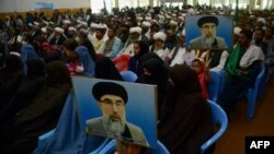 FILE: Supporters of Gulbuddin Hekmatyar, the leader of Hizb-i-Islami, attend a meeting in the western Afghan city of Herat.