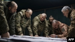 Colonel General Oleksandr Syrskiy (2nd left) and Defense Minister Rustem Umerov (left) visit frontline positions at an undisclosed location in eastern Ukraine on February 14. 