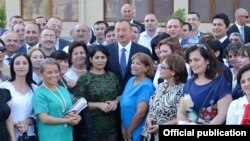 Azerbaijani President Ilham Aliyev meets with journalists at the inauguration ceremony for the new apartment building in Baku.