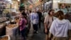 People walk along an alley of Tehran's Tajrish Bazaar on June 2. The prices of staple food items and medicines have skyrocketed since the start of the US-Israeli war with Iran. 