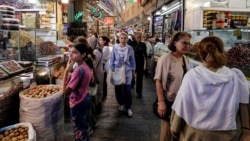 People walk along an alley of Tehran's Tajrish Bazaar on June 2. The prices of staple food items and medicines have skyrocketed since the start of the US-Israeli war with Iran. 