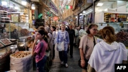 People walk along an alley of Tehran's Tajrish Bazaar on June 2. The prices of staple food items and medicines have skyrocketed since the start of the US-Israeli war with Iran. 