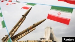 Bunting of Iranian flags next to missiles on display, with Azadi Tower in the background, during the 47th anniversary of the Islamic revolution in Tehran on February 11.