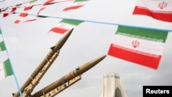 Isticanje zastava Irana pored izloženih raketa na obilježavanju 47. godišnjice Islamske revolucije u Teheranu, 11. februara 2026.