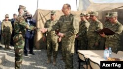 Azerbaijani President Ilham Aliyev (center) visits a military unit in Agdam, on the front line of the battle over Armenian-occupied Nagorno-Karabakh, on August 6.
